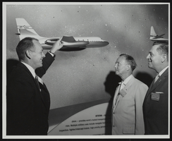 J. F. Waters explains design and performance characteristics of the Lockheed jet transport Jet-Star to Senators Stephen Young and Howard Cannon at the World Congress of Flight, Las Vegas, Nevada: photographic print