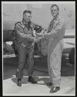 Howard Cannon in flight gear with an unidentified man in front of an aircraft: photographic print