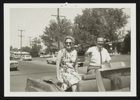 Howard Cannon and his wife Dorothy riding on the back of a convertible during a political campaign: photographic print