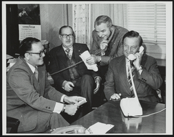 Howard Cannon telephones Vice-President Nelson Rockefeller with Senators Robert Byrd, Hugh Scott, and Robert Griffin to inform him of the Senate's vote to confirm him: photographic print