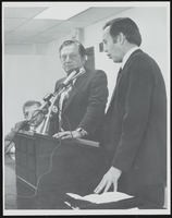 Howard Cannon at a podium with two others: photographic print