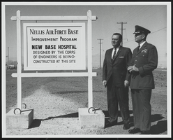 Howard Cannon and a United States Air Force officer observe a sign: photographic print