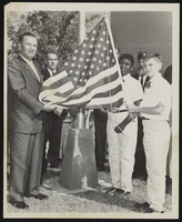 Howard Cannon with a group next to a flag pole: photographic print