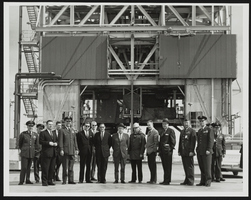 Senatorial committee poses in front of the National Aeronautics and Space Administration rocket engine test stand: photographic print