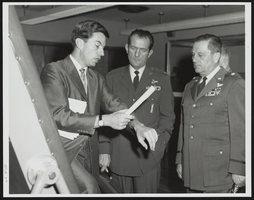 Dr. Lawrence E. Lamb, Chief of the United States Air Force School of Aerospace Medicine's Sciences Division describes to Howard Cannon evaluations given to astronaut candidates: photographic print