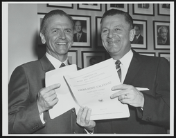 Howard Cannon with unidentified congressional colleague holding a copy of the Legislature Calendar of the 86th Congress: photographic print