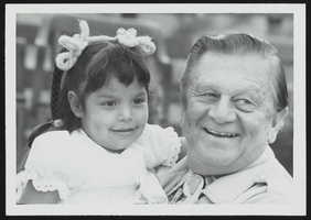Howard Cannon holding a child, Colette Swain, during a visit to the Moapa Indian Reservation: photographic print