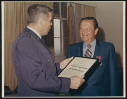 Howard Cannon is presented a Certificate of Appreciation by the United States Air Force upon his retirement from the Air Force Reserve with the rank of Major General: photographic print