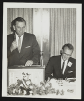 Howard Cannon on podium with an unidentified man: photographic print