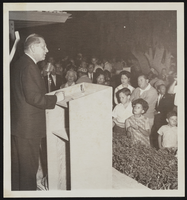 Howard Cannon delivering speech on podium: photographic print