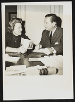 Howard Cannon seated with an unidentified woman: photographic print