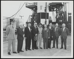 Howard Cannon posed with unidentified men in front of a missile silo: photographic print