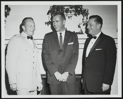 Howard Cannon speaking with two unidentified men: photographic print