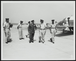 Howard Cannon speaking with United States Air Force personnel at an airfield: photographic print