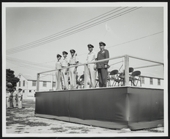 Howard Cannon with United States Air Force personnel on a speaking platform: photographic print