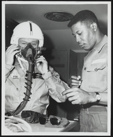 Howard Cannon in a Republic F-105 Thunderchief flight suit with an unidentified man: photographic print