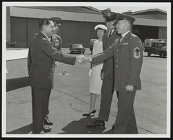 Howard Cannon posed with United States Air Force personnel and an unidentified woman at Kingsley Field, Klamath Falls, Oregon: photographic print