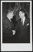 Howard Cannon shaking hands with an unidentified man: photographic print