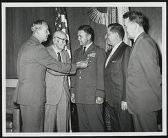 Howard Cannon with unidentified men at a medal award ceremony: photographic print