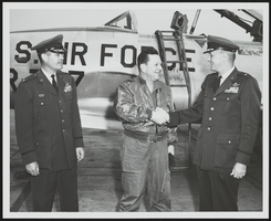 Howard Cannon with two United States Air Force personnel in front of an aircraft: photographic print