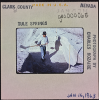 Photographic slide of a man shoveling at Tule Springs, Nevada, January 16, 1963