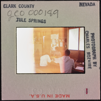 Photographic slide of people inside a cook shack at Tule Springs, Nevada, circa 1962-1963