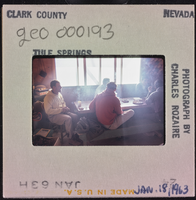 Photographic slide of people inside a cook shack at Tule Springs, Nevada, January 18, 1963