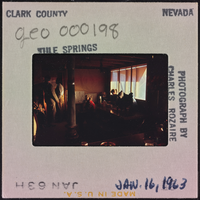 Photographic slide of people inside a cook shack at Tule Springs, Nevada, January 16, 1963