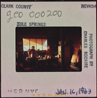 Photographic slide of people inside a cook shack at Tule Springs, Nevada, January 16, 1963