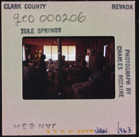 Photographic slide of people inside a cook shack at Tule Springs, Nevada, January 1963