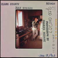 Photographic slide of a man inside a cook shack at Tule Springs, Nevada, January 18, 1963