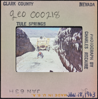 Photographic slide of a man and a tractor, Tule Springs, Nevada, January 18, 1963