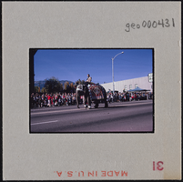 Photographic slide of a man riding an elephant in a parade in Carson City, Nevada, October 31, 1963