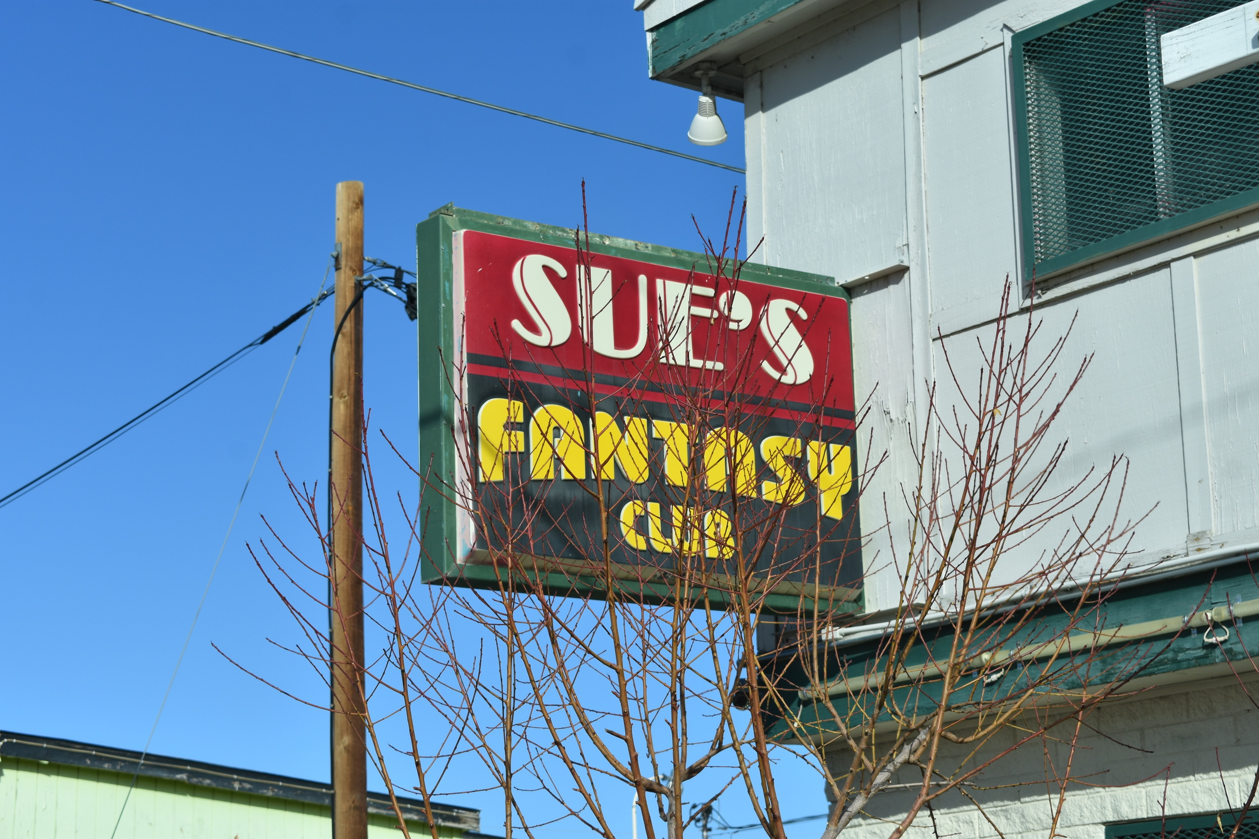 Sue's Fantasy Club flag and other wall mounted signs, Elko, Nevada