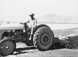 M.P. "Gless" Glessner sitting on the Ford tractor: photographic print