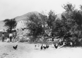 Chickens and four individuals in Resting Spring, California: photographic print
