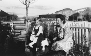 Jimmy Lisle with his maternal grandmother Lottie Mills, in the front yard of a house on Montgomery Street, Beatty, Nevada: photographic print