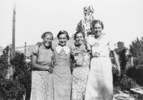 Lorraine Thomas, Babe Palsgrove, Chloe Lisle, and Florence Phinney (identified from left to right) smiling: photographic print