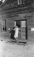 Unidentified woman and the front side of the old Town Hall, Beatty, Nevada: photographic print