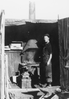 Fred Davies, long-time Beatty resident, working in his blacksmith shop at Pioneer, Nevada: photographic print