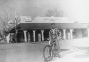 Jim Hendershot in front of the Shell Service Station, Third and Main Streets: photographic print