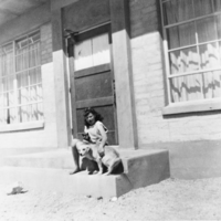 Claudia Davies Reidhead and her dog in front of Beatty High School: photographic print