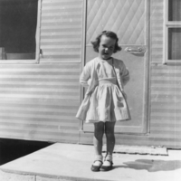 Joyce Ruud at age four standing before the trailer the family moved from California to Pahrump: photographic print