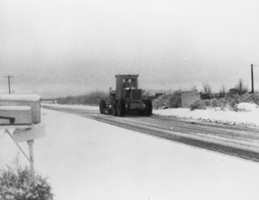 Grader removing snow from Pahrump Valley: photographic print