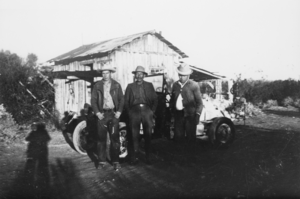 Steve Brown, Marcus Fizaldi, and Steve Brown's uncle, Bob Lee, in front of Bob Lee's home in the Pahrump Valley, Nevada: photographic print