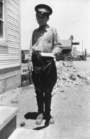 Albert Bradshaw in his Western Union delivery boy's uniform, delivering a telegram: photographic print