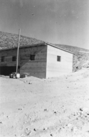 Living quarters constructed by Norman "Curly" Coombs at the tungsten mine in Iron Canyon, Nevada: photographic print