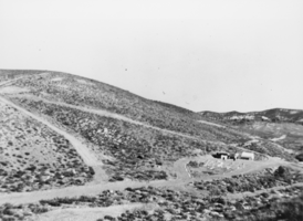 Long view of the early stages of construction of the cabin and mill in Iron Canyon, Railroad Valley, Nevada: photographic print