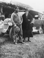 Johnny Reed and a woman of unknown identity in front of a car: photographic print