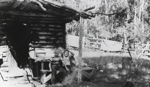 Dick and Gary Carver (identified from left to right) in front of the cabin on the Wardenot pasture, Nevada: photographic print